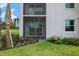 Exterior view of a screened patio overlooking a well-manicured lawn and landscaping at 43981 Boardwalk Loop # 2218, Punta Gorda, FL 33982