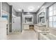 Modern bathroom featuring double vanities, walk-in shower, and separate tub at 1064 Harbour Way Pl, Punta Gorda, FL 33983