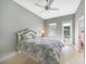 Bedroom with ceiling fan, access to the pool area, and light wood-look flooring at 1064 Harbour Way Pl, Punta Gorda, FL 33983