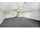 Spacious bedroom with gray carpeting, a ceiling fan, and white closet doors at 1064 Harbour Way Pl, Punta Gorda, FL 33983