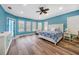 Spacious main bedroom with blue walls, wood-look floors, and lots of natural light at 1064 Harbour Way Pl, Punta Gorda, FL 33983