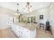 White kitchen cabinets, granite countertops, and an island cooktop at 1064 Harbour Way Pl, Punta Gorda, FL 33983