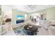 Open and airy living room with tile flooring, a ceiling fan, and views into the kitchen at 1064 Harbour Way Pl, Punta Gorda, FL 33983