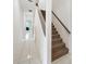 Carpeted staircase in a hallway with white tile floors at 1064 Harbour Way Pl, Punta Gorda, FL 33983