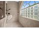Spa-like shower with glass block window and neutral tile at 1422 Kittiwake Dr, Punta Gorda, FL 33950