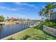 Landscaped backyard with private dock and canal access at 1422 Kittiwake Dr, Punta Gorda, FL 33950