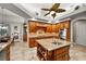 Spacious kitchen boasts wood cabinets, granite island, and stainless steel appliances at 1422 Kittiwake Dr, Punta Gorda, FL 33950