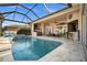 Enclosed pool and spa with water features and patio area at 1422 Kittiwake Dr, Punta Gorda, FL 33950