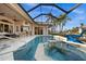 Resort-style pool and spa with covered patio overlooking canal at 1422 Kittiwake Dr, Punta Gorda, FL 33950