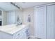 Vanity with marble countertop, large mirror, and ample storage at 150 Harborside Ave # 313, Punta Gorda, FL 33950