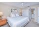 Main bedroom with king-size bed, ceiling fan, and en-suite bathroom access at 150 Harborside Ave # 313, Punta Gorda, FL 33950