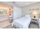 Guest bedroom with twin beds, ceiling fan, and adjacent bathroom at 150 Harborside Ave # 313, Punta Gorda, FL 33950