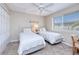 Guest bedroom with two twin beds, ceiling fan and window with blinds at 150 Harborside Ave # 313, Punta Gorda, FL 33950