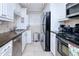 Modern kitchen featuring stainless steel appliances and granite countertops at 150 Harborside Ave # 313, Punta Gorda, FL 33950