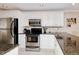 White kitchen cabinets, granite countertops, and stainless steel appliances at 150 Harborside Ave # 313, Punta Gorda, FL 33950