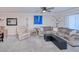 Relaxing living room with sectional sofa, ceiling fan, and ample natural light at 150 Harborside Ave # 313, Punta Gorda, FL 33950