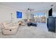 Bright living room with comfy seating, large windows, and access to balcony at 150 Harborside Ave # 313, Punta Gorda, FL 33950