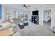 Spacious living area featuring a sectional sofa, sliding doors to balcony, and a view of the bedroom at 150 Harborside Ave # 313, Punta Gorda, FL 33950