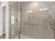 Modern bathroom featuring walk-in shower with glass enclosure and tile walls at 1833 Marconi Ave, North Port, FL 34286