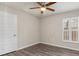 Empty bedroom with wood-look flooring, plantation shutters, and neutral walls at 1833 Marconi Ave, North Port, FL 34286