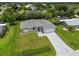New construction home with gray roof and paver driveway at 18854 Ackerman Ave, Port Charlotte, FL 33948