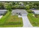 New construction home with gray roof and paver driveway at 18854 Ackerman Ave, Port Charlotte, FL 33948
