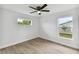 Bright bedroom with wood-look floors and two windows at 18854 Ackerman Ave, Port Charlotte, FL 33948