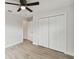 Bright bedroom with ceiling fan, large closet, and wood-look floors at 18854 Ackerman Ave, Port Charlotte, FL 33948