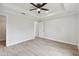 Spacious bedroom with ceiling fan and access to bathroom at 18854 Ackerman Ave, Port Charlotte, FL 33948