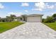 New construction home with a paved driveway and landscaping at 18854 Ackerman Ave, Port Charlotte, FL 33948