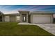 Modern house exterior with two-car garage and landscaped lawn at 18854 Ackerman Ave, Port Charlotte, FL 33948