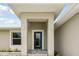 Modern house entrance with a blue door and stone flooring at 18854 Ackerman Ave, Port Charlotte, FL 33948