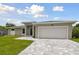 Tan house exterior with a white garage door at 18854 Ackerman Ave, Port Charlotte, FL 33948