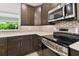Stainless steel appliances and dark cabinetry in this updated kitchen at 18854 Ackerman Ave, Port Charlotte, FL 33948