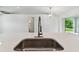 Modern kitchen features a large island with stainless steel sink and white quartz countertops at 18854 Ackerman Ave, Port Charlotte, FL 33948