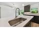 Modern kitchen sink and faucet with an open concept layout at 18854 Ackerman Ave, Port Charlotte, FL 33948