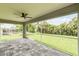 Spacious screened patio with paver stones and view of backyard at 18854 Ackerman Ave, Port Charlotte, FL 33948