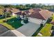 Charming home with tile roof, attached garage, and lush landscaping at 1946 Cove Pointe Dr, Venice, FL 34293