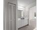 Bathroom vanity with white cabinets, mirror, and light fixture at 1946 Cove Pointe Dr, Venice, FL 34293
