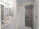 Bathroom with white vanity, shower, and louvered closet door at 1946 Cove Pointe Dr, Venice, FL 34293