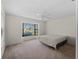Bright bedroom with large window and plush carpet at 1946 Cove Pointe Dr, Venice, FL 34293
