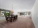 Dining area with chandelier, table, and view of the pool and backyard at 1946 Cove Pointe Dr, Venice, FL 34293