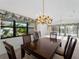 Dining room with chandelier, table, and view of the pool at 1946 Cove Pointe Dr, Venice, FL 34293