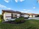 Side view of home with large window, landscaping, and attached garage at 1946 Cove Pointe Dr, Venice, FL 34293