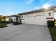 Front exterior view of home with attached garage and landscaping at 1946 Cove Pointe Dr, Venice, FL 34293