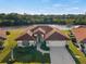 Attractive waterfront home with tile roof, attached garage, and landscaped yard at 1946 Cove Pointe Dr, Venice, FL 34293