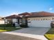 Inviting single-story home with tile roof, attached garage, and well-maintained landscaping at 1946 Cove Pointe Dr, Venice, FL 34293