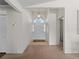 Bright and spacious foyer with high ceilings, a decorative light fixture, and carpeted flooring at 1946 Cove Pointe Dr, Venice, FL 34293