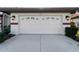Attached two-car garage with decorative windows and paved driveway at 1946 Cove Pointe Dr, Venice, FL 34293