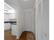 Hallway with closet space and view of the kitchen at 1946 Cove Pointe Dr, Venice, FL 34293